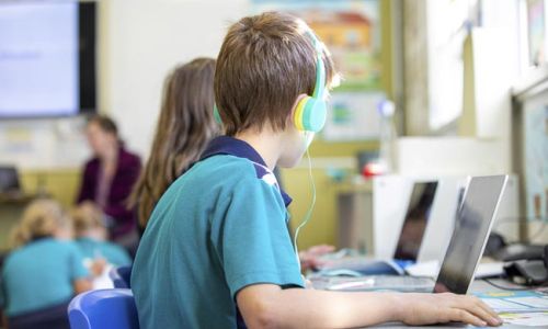 Junior School students using laptops to assist with learning